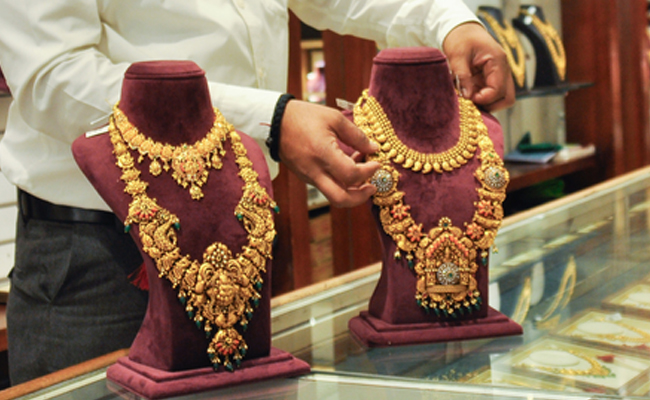 Gold prices surge to record high amid safe haven demand