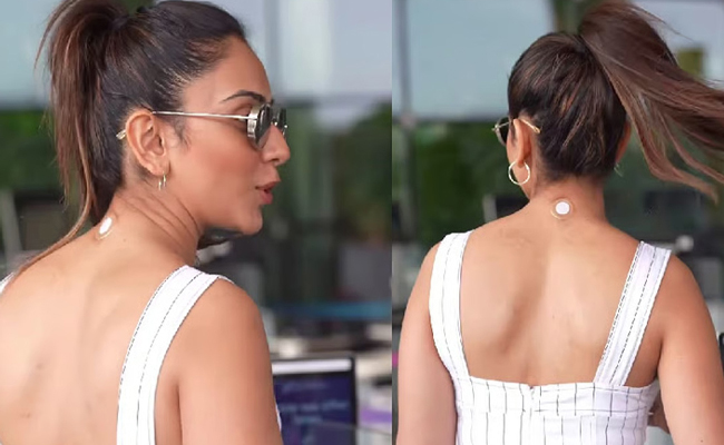 What’s that sticker on Rakul’s neck?